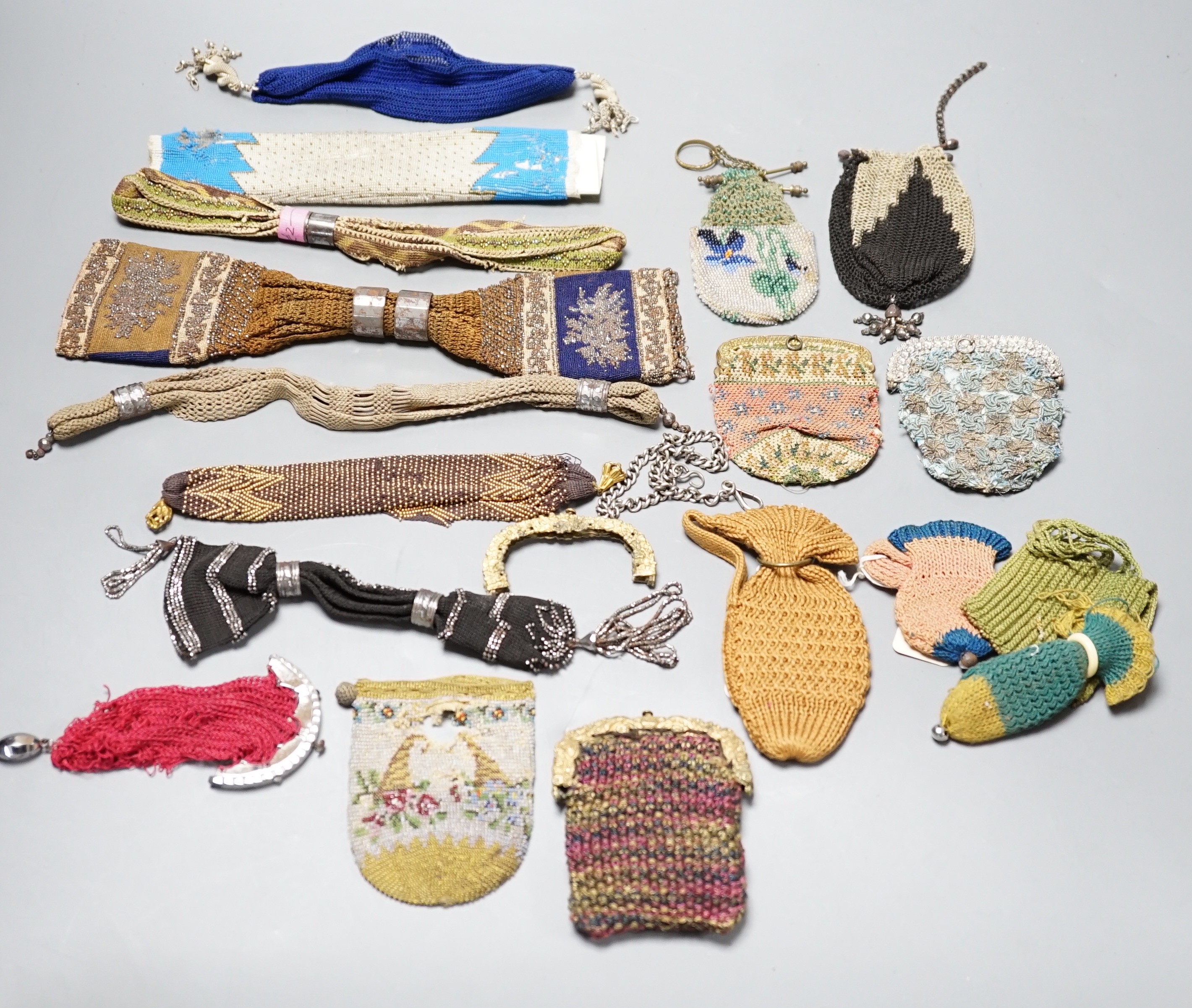 Seven 19th century cut steel misers purses, five beaded and knitted metal framed purses, two reticules, two novelty knitted jug shaped purses and two others